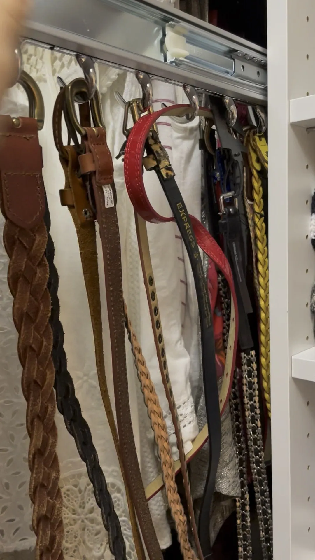 Belts hung individually on a pull-out rack